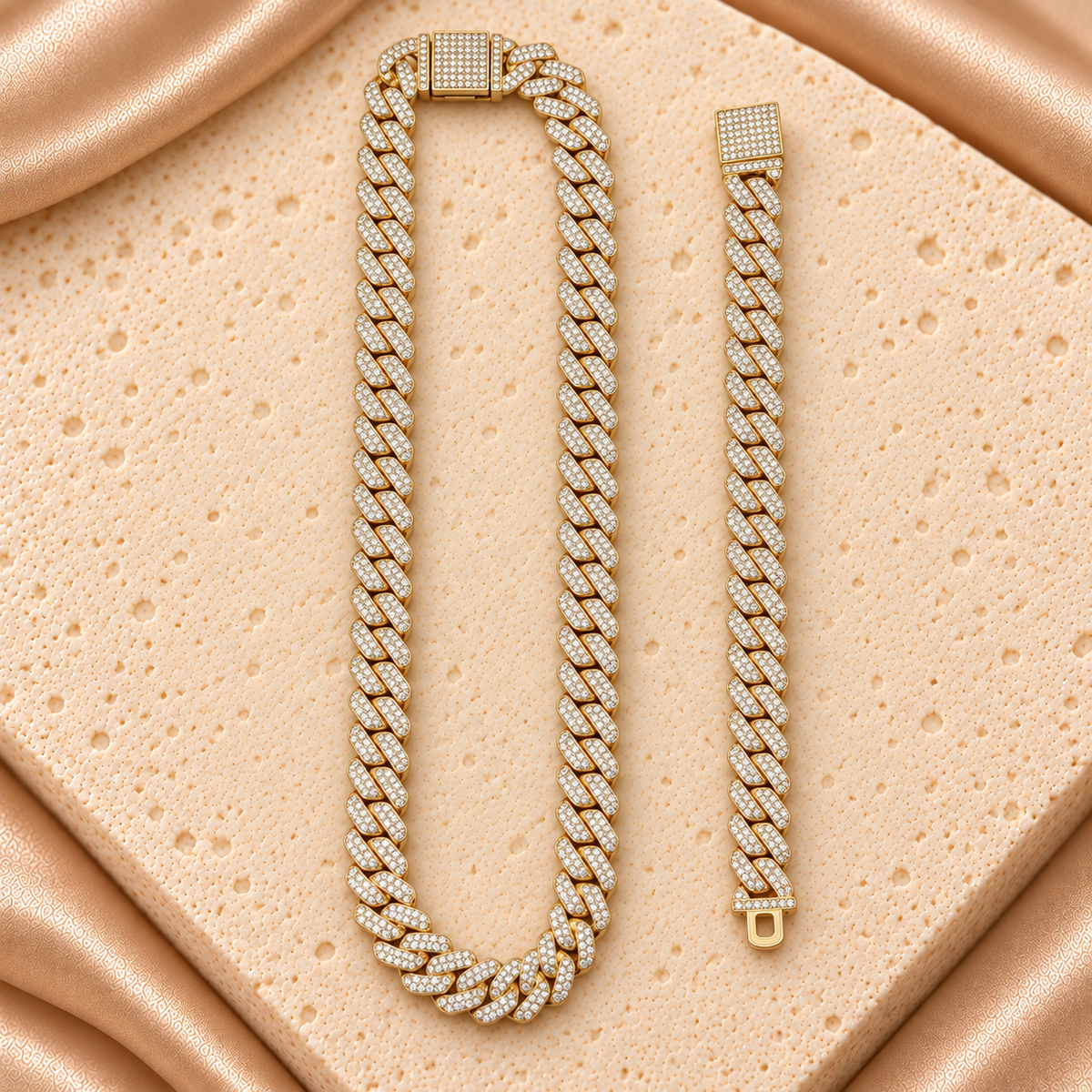 Set en tono dorado de cadena y pulsera con eslabones cubanos cubiertos de pequeñas piedras transparentes y cierres rectangulares brillantes.